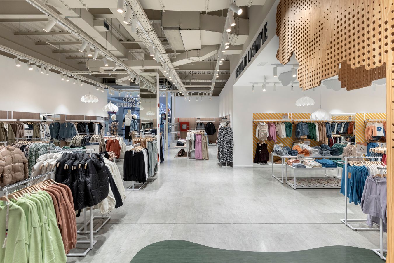BAS Store - Spacious retail interior with organized clothing racks and industrial ceiling details - Contract Workplaces.jpg
